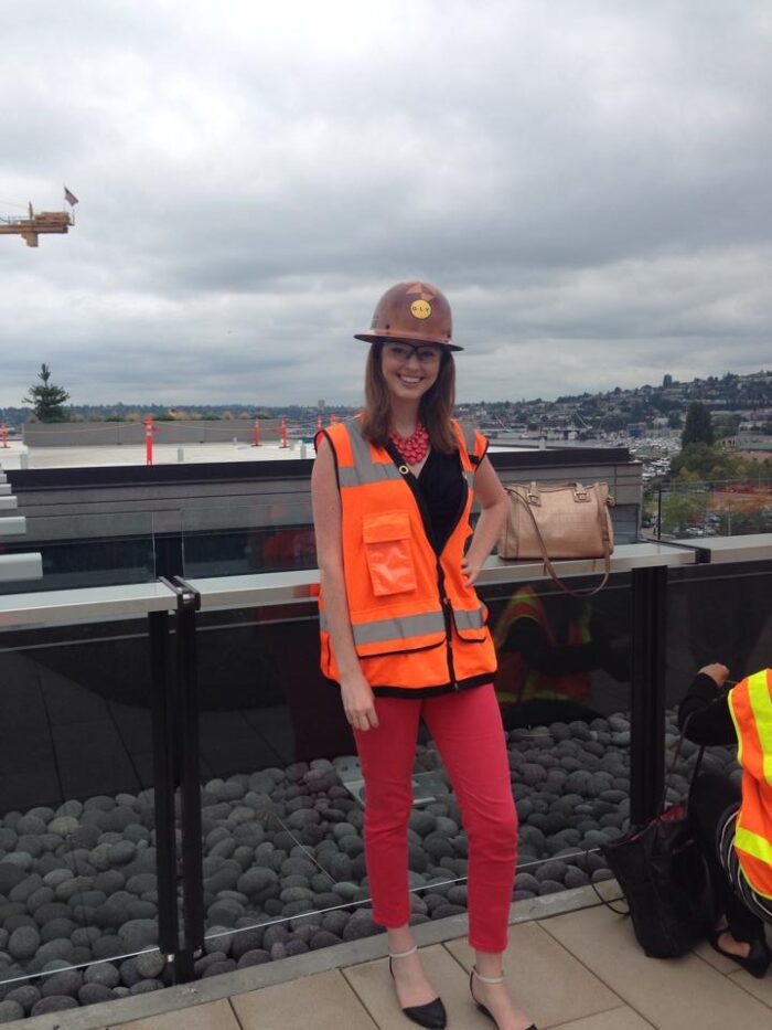 Amanda Sellsted at a job site in a hard hat and vest during her time at her first firm