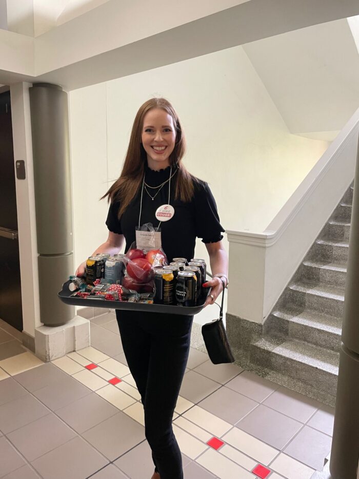 Amanda Sellsted holding a tray of snacks at a Career Fair she attended with BCRA
